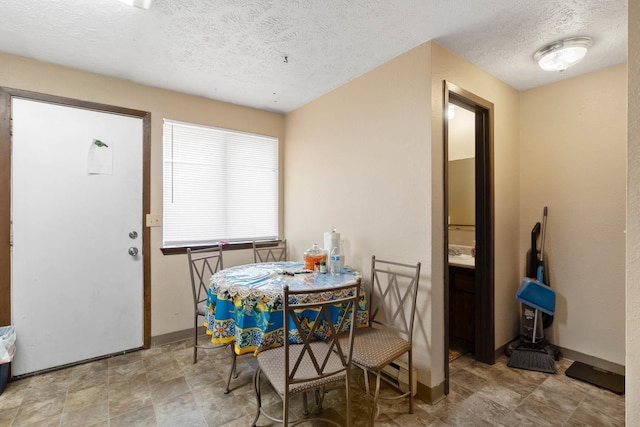 1526-1528 E Rowan Ave, Spokane, WA 99207 - dining room with a textured ceiling and baseboards