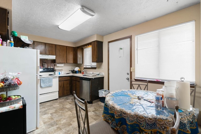 1526-1528 E Rowan Ave, Spokane, WA 99207 - kitchen featuring white appliances, light countertops, under cabinet range hood, and a textured ceiling