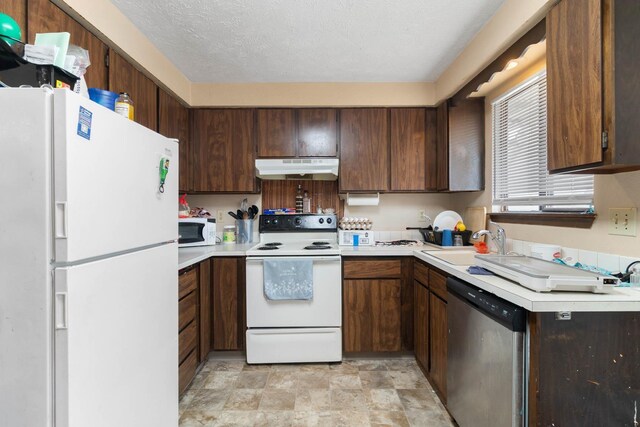 1526-1528 E Rowan Ave, Spokane, WA 99207 - kitchen with white appliances, under cabinet range hood, light countertops, and stone finish flooring