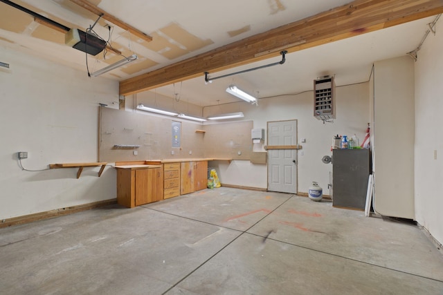 13419 N Whitehouse Ct, Spokane, WA 99208 - garage featuring a garage door opener, a workshop area, electric panel, and a heating unit