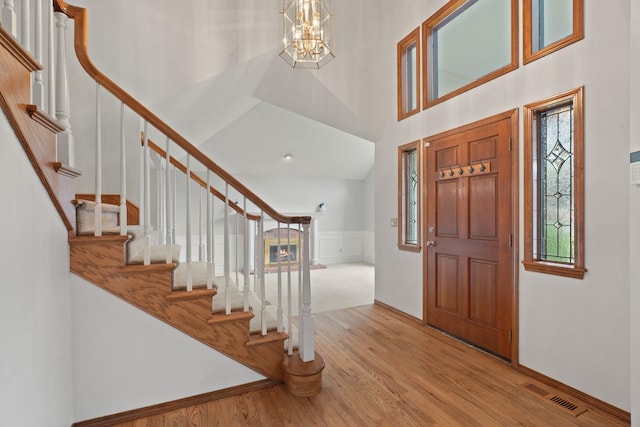 13419 N Whitehouse Ct, Spokane, WA 99208 - entryway featuring wood finished floors, a chandelier, a towering ceiling, and stairs