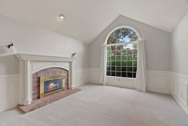 13419 N Whitehouse Ct, Spokane, WA 99208 - unfurnished living room featuring carpet flooring, a wainscoted wall, a decorative wall, a fireplace, and vaulted ceiling