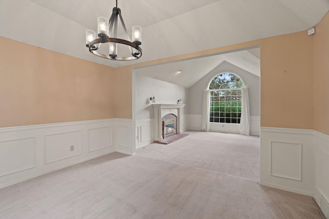 13419 N Whitehouse Ct, Spokane, WA 99208 - unfurnished living room with a chandelier, lofted ceiling, wainscoting, light colored carpet, and a decorative wall