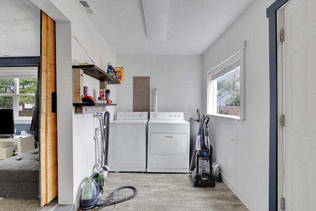 2403 W Mallon Ave, Spokane, WA 99201 - laundry room featuring independent washer and dryer, light wood-style floors, healthy amount of natural light, and electric panel