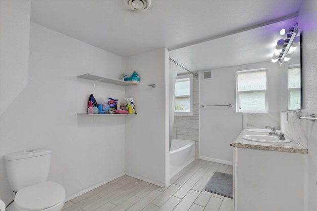 2403 W Mallon Ave, Spokane, WA 99201 - bathroom featuring double vanity, bathing tub / shower combination, and wood finish floors