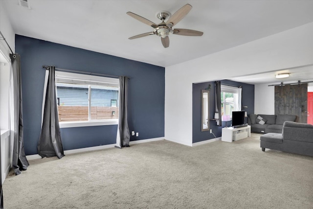 2403 W Mallon Ave, Spokane, WA 99201 - carpeted living room with a barn door and a ceiling fan