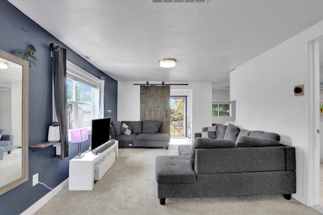 2403 W Mallon Ave, Spokane, WA 99201 - living area featuring a barn door, carpet floors, and plenty of natural light