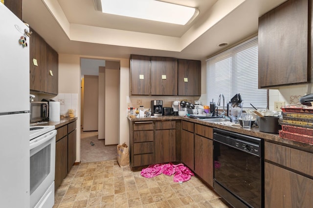 11816-11818 N Wall St, Spokane, WA 99218 - kitchen with black appliances, decorative backsplash, a raised ceiling, and dark countertops
