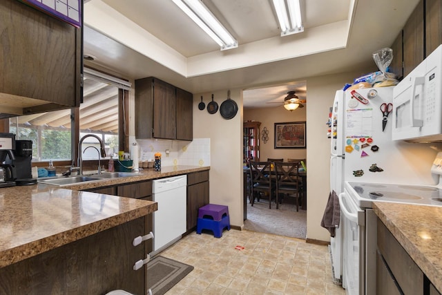 11816-11818 N Wall St, Spokane, WA 99218 - kitchen with white appliances, dark brown cabinets, ceiling fan, tasteful backsplash, and a tray ceiling