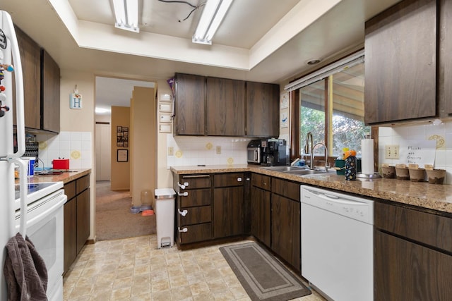 11816-11818 N Wall St, Spokane, WA 99218 - kitchen featuring white appliances, tasteful backsplash, dark brown cabinetry, and a raised ceiling