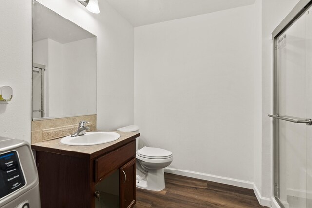 18108 E Crescent Dr, Greenacres, WA 99016 - full bath with washer / clothes dryer, vanity, wood finished floors, and an enclosed shower