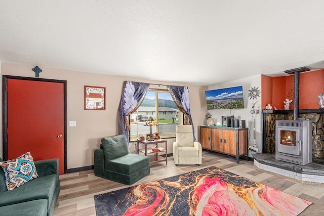 1503 E 3rd St, Post Falls, ID 83854 - living room with heating unit, a wood stove, and wood finished floors