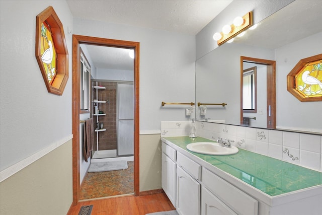 4319 S Myrtle St, Spokane, WA 99223 - full bath with wood finished floors, vanity, and tiled shower
