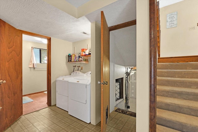 4319 S Myrtle St, Spokane, WA 99223 - washroom with washing machine and dryer, light flooring, and a textured ceiling