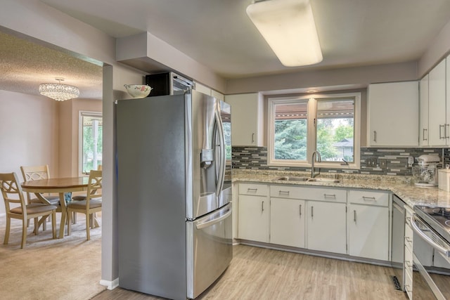 1026 W Bellwood Dr, Spokane, WA 99218 - kitchen with stainless steel appliances, plenty of natural light, and backsplash