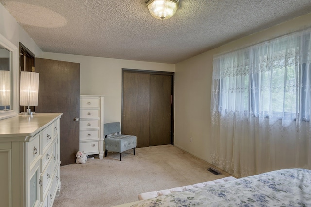 1026 W Bellwood Dr, Spokane, WA 99218 - bedroom with light carpet, a textured ceiling, and a closet