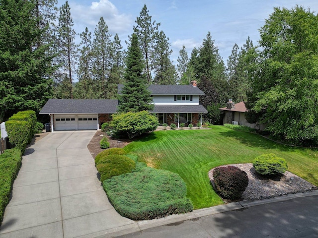 1026 W Bellwood Dr, Spokane, WA 99218 - traditional-style home with driveway, a front lawn, a garage, a chimney, and brick siding
