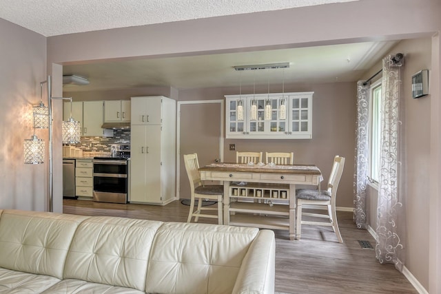 1026 W Bellwood Dr, Spokane, WA 99218 - dining room featuring baseboards and wood finished floors
