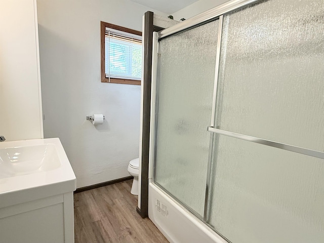 1710 E Crown Ave, Spokane, WA 99207 - bathroom featuring wood finished floors, vanity, and shower / bath combination with glass door