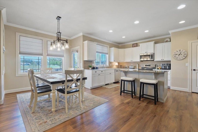 1716 W Country Hunt Ln, Spokane, WA 99224 - dining room with plenty of natural light, crown molding, recessed lighting, a chandelier, and dark wood-style flooring