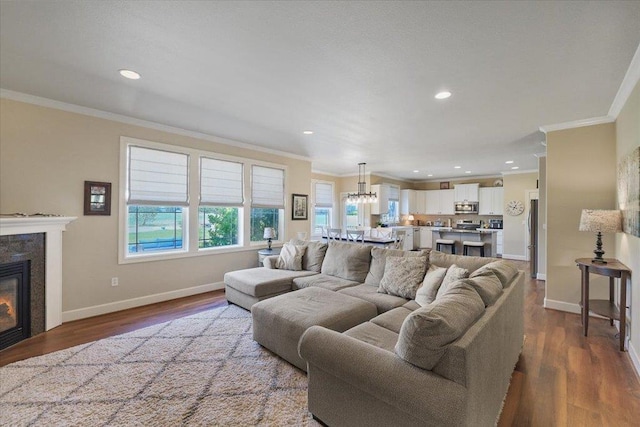 1716 W Country Hunt Ln, Spokane, WA 99224 - living area featuring crown molding, a premium fireplace, a chandelier, dark wood finished floors, and recessed lighting