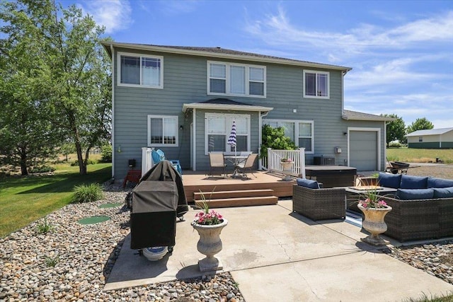 1716 W Country Hunt Ln, Spokane, WA 99224 - rear view of property featuring a wooden deck, a hot tub, a patio, a garage, and an outdoor hangout area