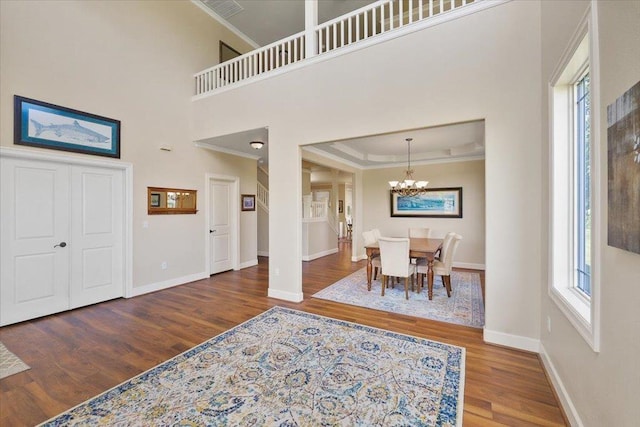 1716 W Country Hunt Ln, Spokane, WA 99224 - dining room with crown molding, wood finished floors, a chandelier, and a towering ceiling