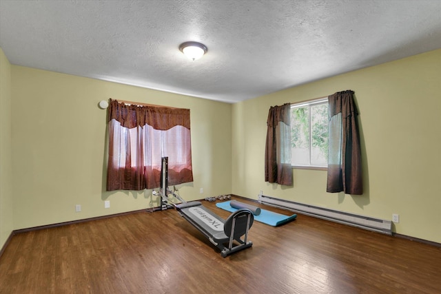 42503 N Regal Rd, Elk, WA 99009 - exercise area with baseboard heating, wood finished floors, and a textured ceiling