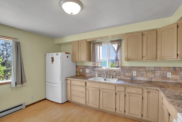 42503 N Regal Rd, Elk, WA 99009 - kitchen featuring freestanding refrigerator, baseboard heating, light brown cabinets, tasteful backsplash, and light wood-style flooring