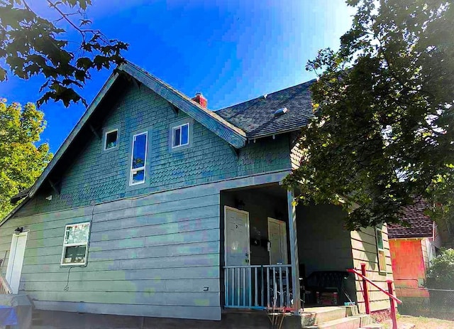 1616 N Cedar Ave, Spokane, WA 99205 - view of home's exterior featuring a chimney and a porch