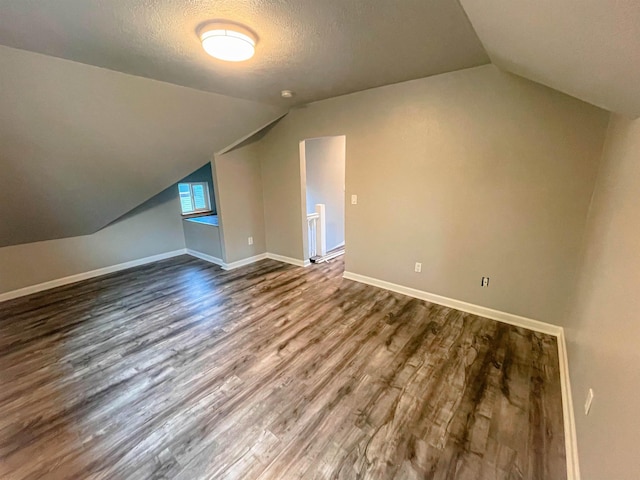 1616 N Cedar Ave, Spokane, WA 99205 - bonus room with vaulted ceiling, dark wood finished floors, and a textured ceiling