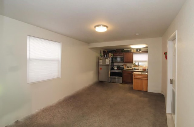1616 N Cedar Ave, Spokane, WA 99205 - kitchen with appliances with stainless steel finishes, brown cabinetry, and dark carpet