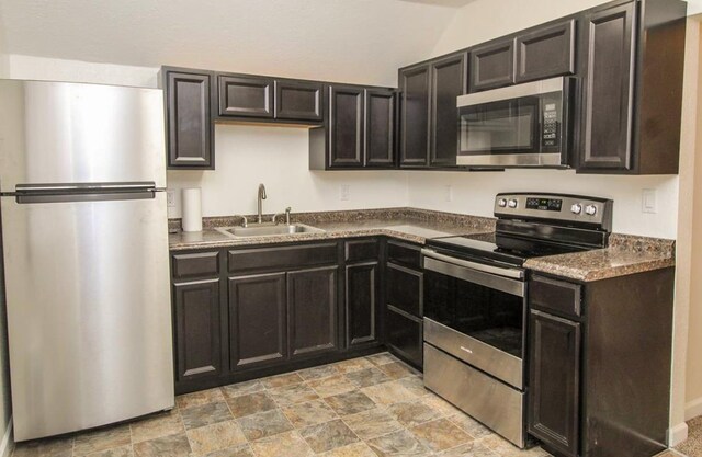1616 N Cedar Ave, Spokane, WA 99205 - kitchen featuring appliances with stainless steel finishes, dark countertops, and stone finish floors