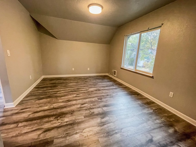 1616 N Cedar Ave, Spokane, WA 99205 - bonus room with dark wood-style floors, vaulted ceiling, and a textured ceiling