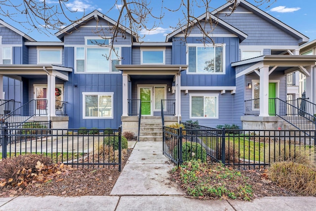 2121 W Bridge Ave Unit 2121, Spokane, WA 99201 - view of front of home featuring board and batten siding and a fenced front yard