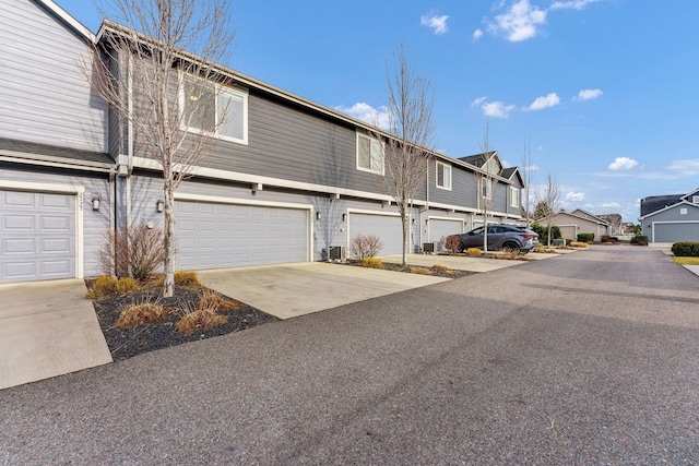 2121 W Bridge Ave Unit 2121, Spokane, WA 99201 - view of front of house featuring a garage, a residential view, and concrete driveway