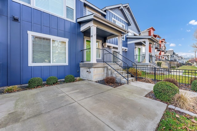 2121 W Bridge Ave Unit 2121, Spokane, WA 99201 - doorway to property with board and batten siding, a patio, and a residential view