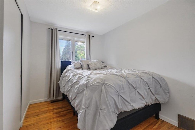 5318 N Walnut St, Spokane, WA 99205 - bedroom featuring vaulted ceiling and wood finished floors