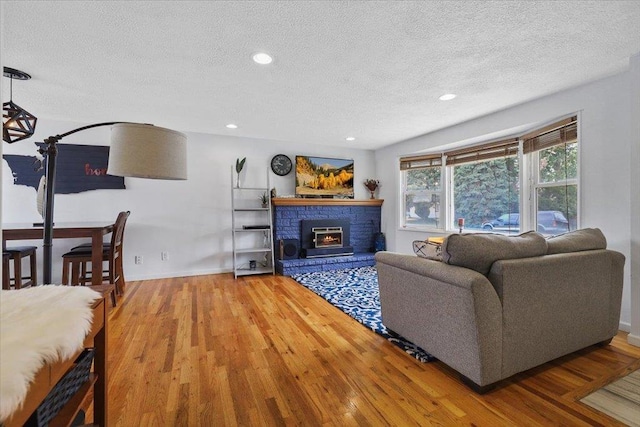 5318 N Walnut St, Spokane, WA 99205 - living room featuring a textured ceiling, wood finished floors, and recessed lighting
