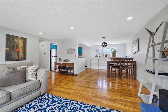 5318 N Walnut St, Spokane, WA 99205 - living room featuring light wood finished floors, a textured ceiling, and recessed lighting