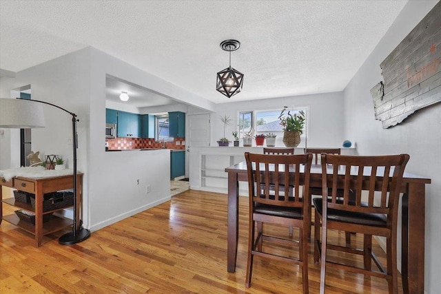 5318 N Walnut St, Spokane, WA 99205 - dining room featuring light wood finished floors and a textured ceiling