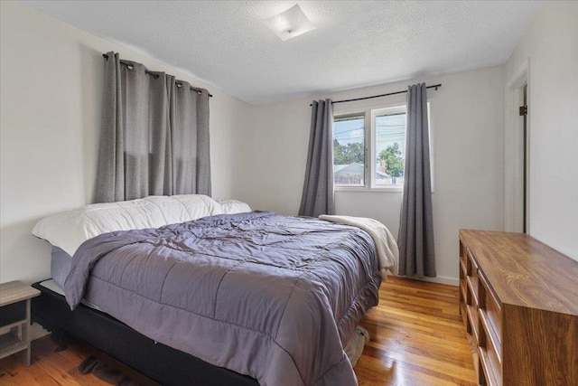 5318 N Walnut St, Spokane, WA 99205 - bedroom with light wood-style floors and a textured ceiling