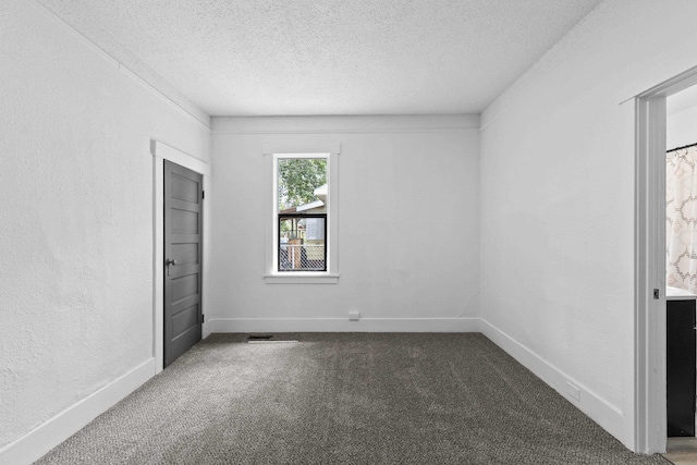 411 S Ferrall St, Spokane, WA 99202 - unfurnished bedroom with carpet flooring, a textured ceiling, and a textured wall