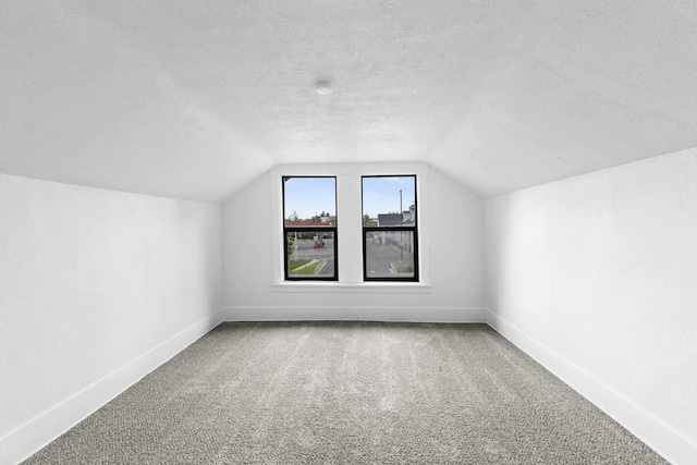 411 S Ferrall St, Spokane, WA 99202 - bonus room featuring vaulted ceiling, carpet floors, and a textured ceiling