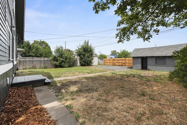 411 S Ferrall St, Spokane, WA 99202 - fenced backyard featuring an outbuilding and a deck
