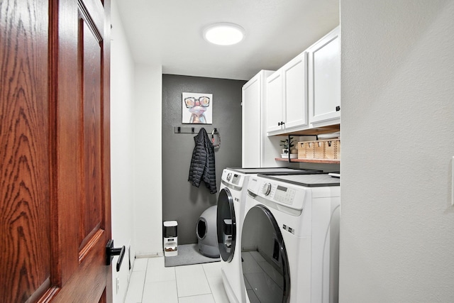 116 W Bristol Ave, Spokane, WA 99224 - laundry room featuring washer and clothes dryer, cabinet space, and light tile patterned floors