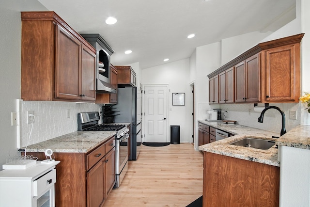 116 W Bristol Ave, Spokane, WA 99224 - kitchen with appliances with stainless steel finishes, light wood-style flooring, decorative backsplash, light stone countertops, and recessed lighting