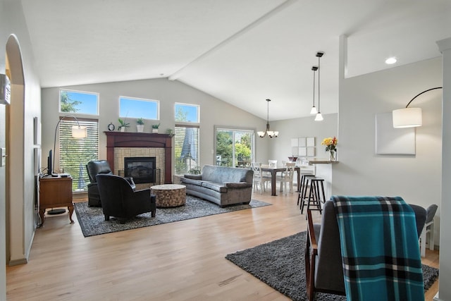 116 W Bristol Ave, Spokane, WA 99224 - living room with a tiled fireplace, light wood finished floors, high vaulted ceiling, and a chandelier