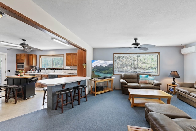 6519I Myrtle Dr, Nine Mile Falls, WA 99026 - living area featuring a ceiling fan, a wall mounted AC, and a textured ceiling