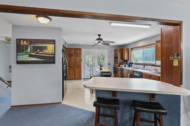 6519I Myrtle Dr, Nine Mile Falls, WA 99026 - kitchen featuring black appliances, brown cabinetry, and a breakfast bar area